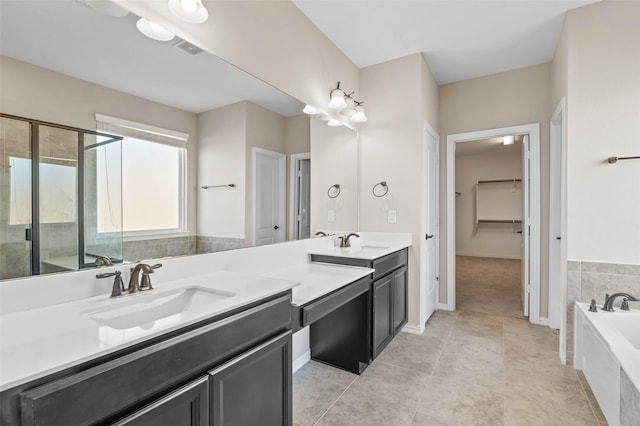 bathroom with vanity, tile patterned floors, and shower with separate bathtub