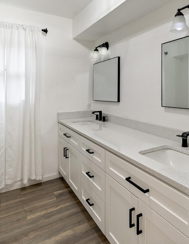 bathroom featuring hardwood / wood-style flooring and vanity