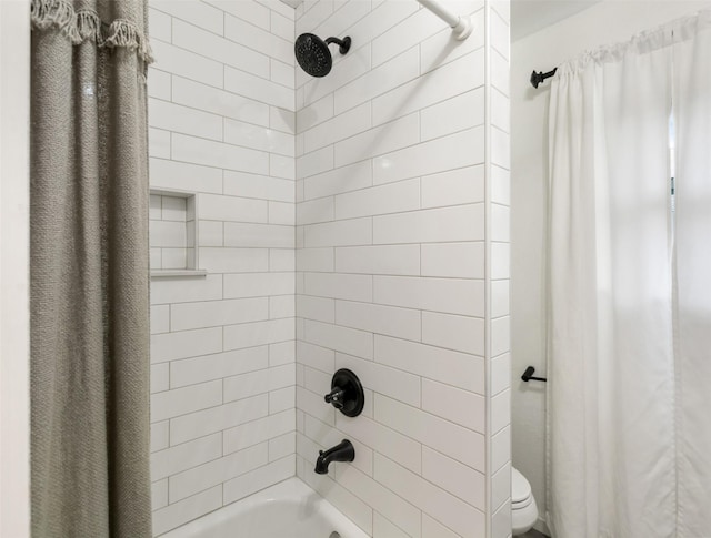 bathroom featuring shower / bath combo and toilet