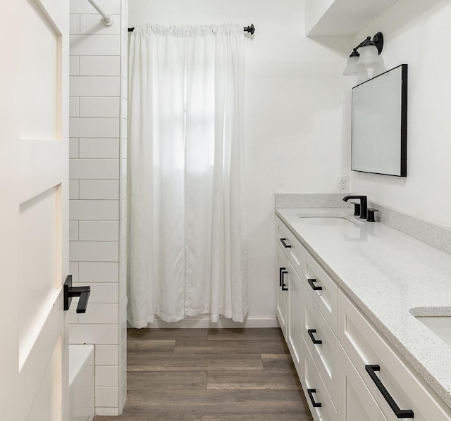 bathroom with shower / bath combination with curtain, vanity, and hardwood / wood-style flooring