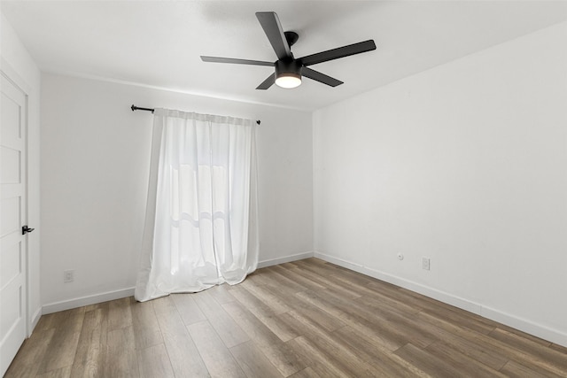 spare room with hardwood / wood-style floors and ceiling fan