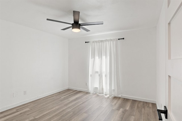 empty room featuring ceiling fan and light hardwood / wood-style flooring