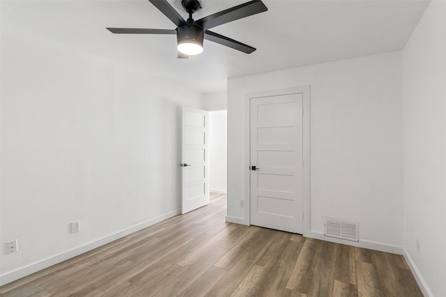 empty room featuring ceiling fan and wood-type flooring