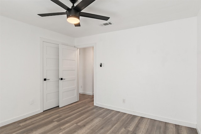 empty room featuring ceiling fan and hardwood / wood-style flooring