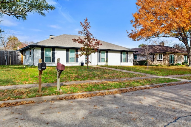 single story home with a front yard