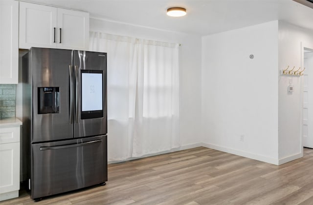 kitchen featuring white cabinetry, stainless steel refrigerator with ice dispenser, and light wood-type flooring