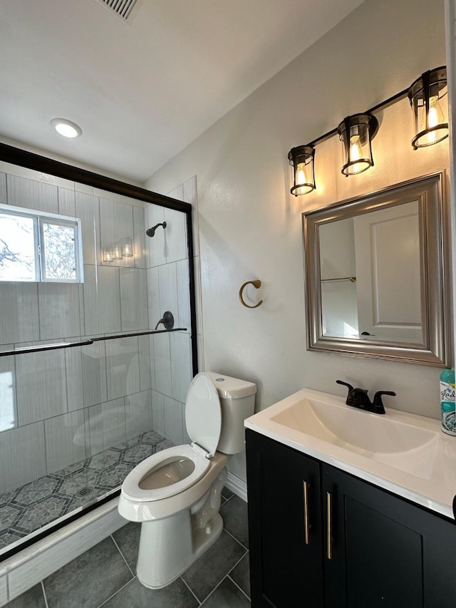 bathroom featuring tile patterned floors, walk in shower, vanity, and toilet