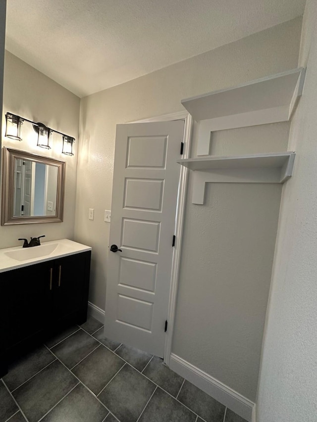 bathroom with tile patterned floors and vanity