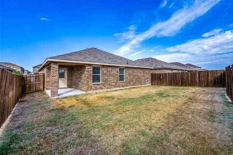 rear view of house featuring a lawn