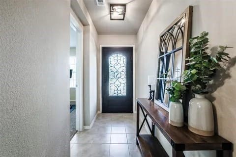 doorway to outside with light tile patterned floors