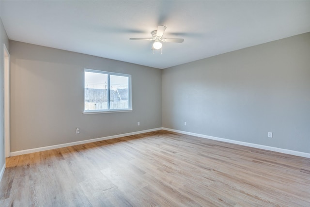 spare room with ceiling fan and light wood-type flooring