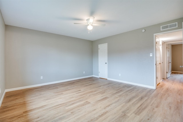 empty room with ceiling fan and light hardwood / wood-style floors