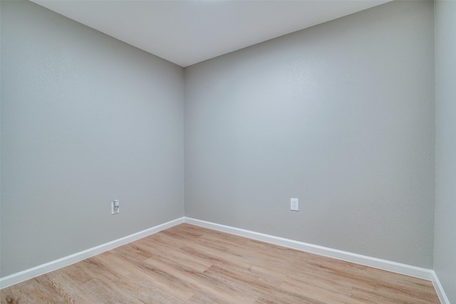 empty room with light hardwood / wood-style flooring