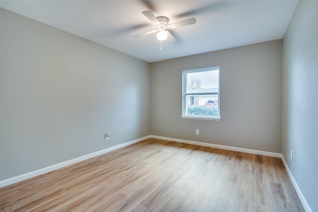 empty room with ceiling fan and light hardwood / wood-style floors