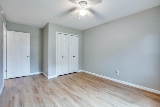 unfurnished bedroom with ceiling fan, light wood-type flooring, and a closet