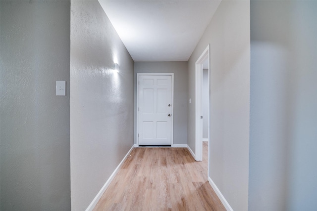 hallway with light hardwood / wood-style floors