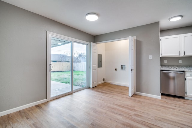 kitchen featuring stainless steel dishwasher, light wood-type flooring, and white cabinetry