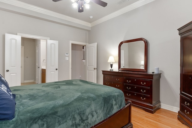 bedroom featuring ceiling fan, ornamental molding, connected bathroom, and light hardwood / wood-style flooring