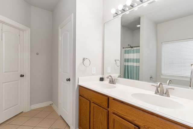 bathroom featuring tile patterned flooring, vanity, and walk in shower