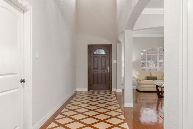 entrance foyer featuring wood-type flooring and ornamental molding