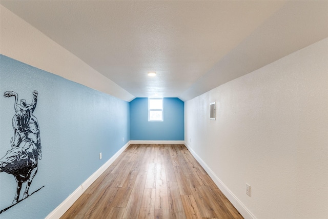 interior space featuring light hardwood / wood-style floors and a textured ceiling