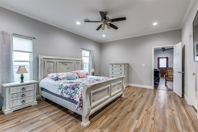 bedroom featuring ceiling fan, ornamental molding, light hardwood / wood-style floors, and multiple windows