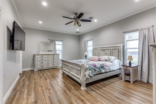 bedroom featuring ornamental molding, ceiling fan, and light wood-type flooring