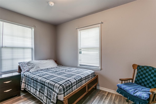 bedroom with dark hardwood / wood-style floors