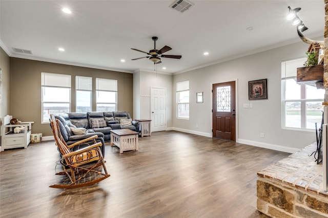 living room with crown molding, ceiling fan, and dark hardwood / wood-style floors