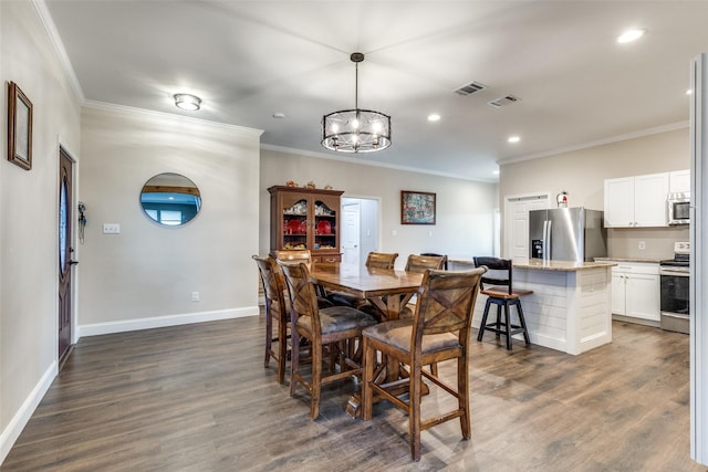 dining room featuring dark wood-type flooring and ornamental molding