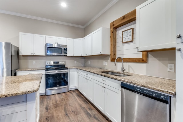 kitchen with sink, white cabinets, and appliances with stainless steel finishes