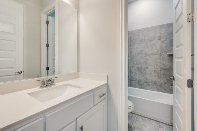 full bathroom featuring tile patterned floors, vanity, toilet, and tiled shower / bath