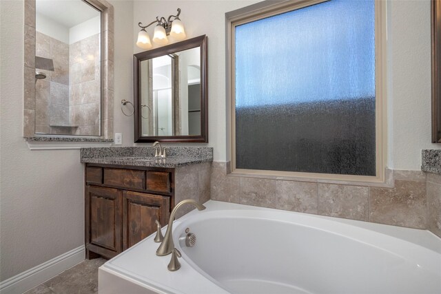 bathroom featuring vanity and a tub