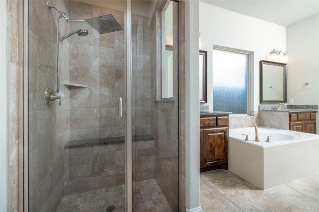 bathroom with tile patterned flooring, shower with separate bathtub, and vanity