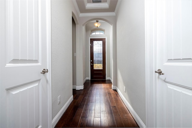 doorway with crown molding and dark hardwood / wood-style floors