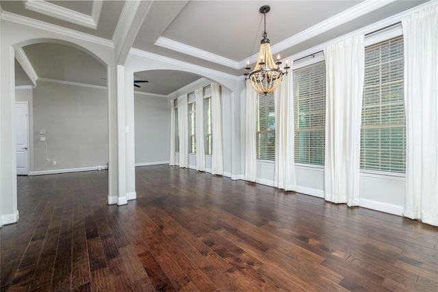 unfurnished dining area featuring dark hardwood / wood-style flooring, ceiling fan with notable chandelier, and ornamental molding