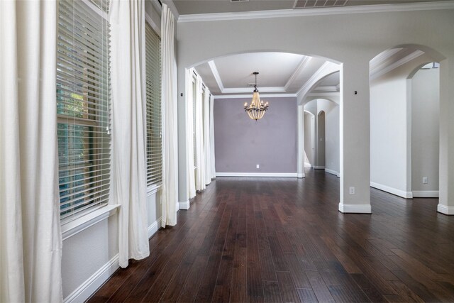 hall with dark hardwood / wood-style flooring, crown molding, and a notable chandelier