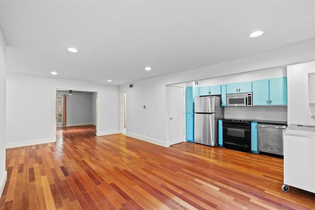 kitchen featuring blue cabinetry, stainless steel appliances, and light hardwood / wood-style flooring