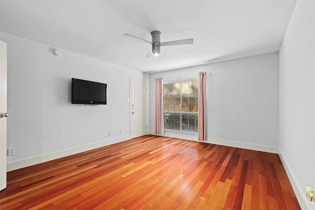 spare room featuring hardwood / wood-style floors and ceiling fan