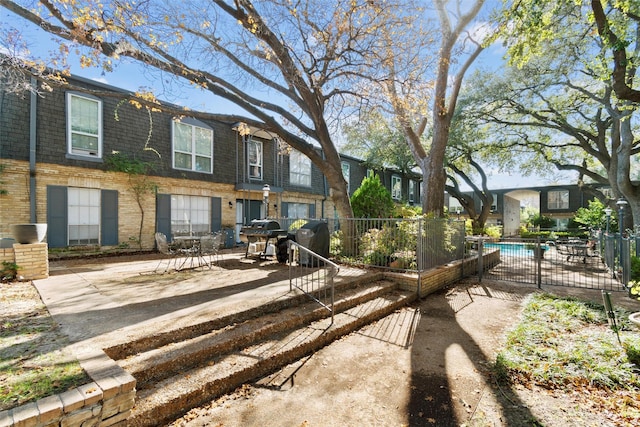 exterior space featuring a fenced in pool and a patio area