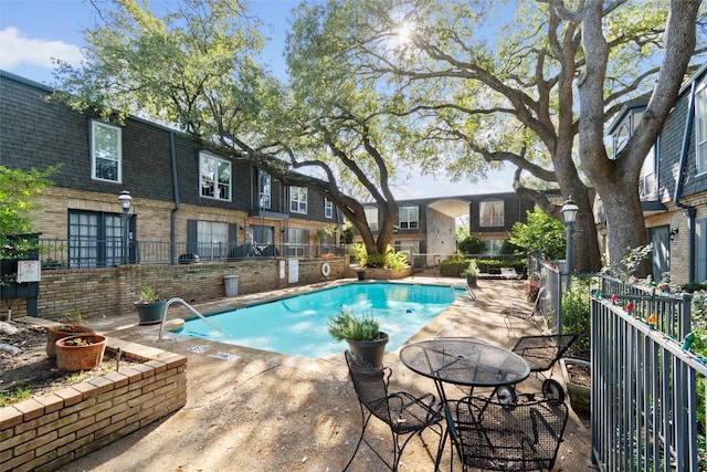 view of pool featuring a patio