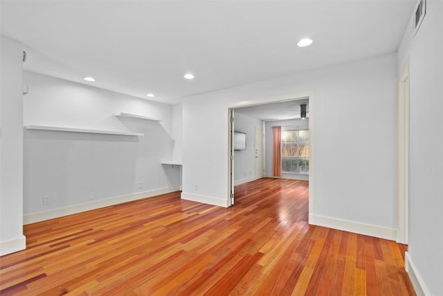 unfurnished living room featuring ceiling fan and light hardwood / wood-style flooring