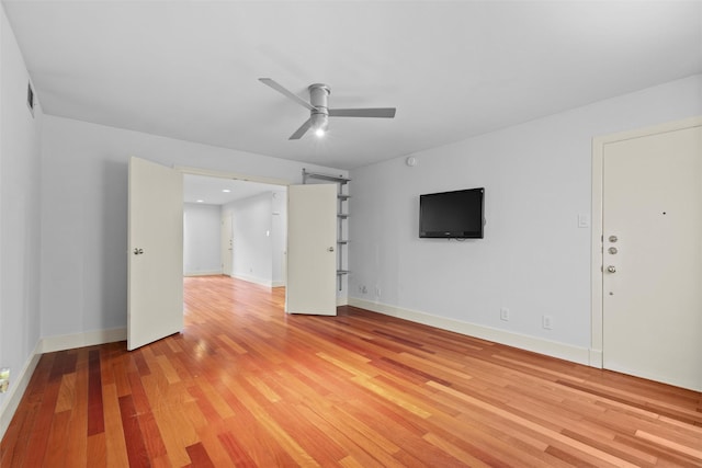 unfurnished living room featuring ceiling fan and light hardwood / wood-style flooring