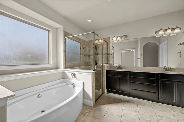 bathroom featuring vanity and independent shower and bath