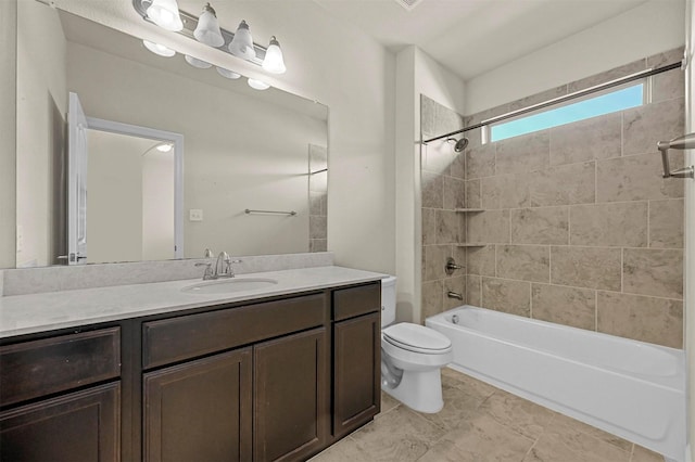 full bathroom with tile patterned floors, tiled shower / bath combo, toilet, and vanity