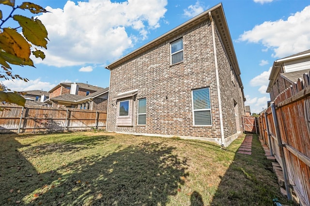 rear view of house with a lawn