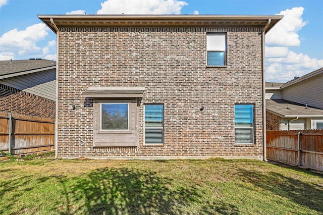 rear view of property with a lawn