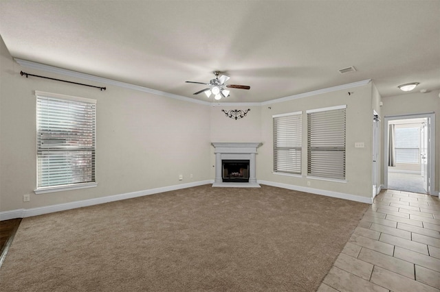 unfurnished living room featuring ceiling fan, light colored carpet, and ornamental molding