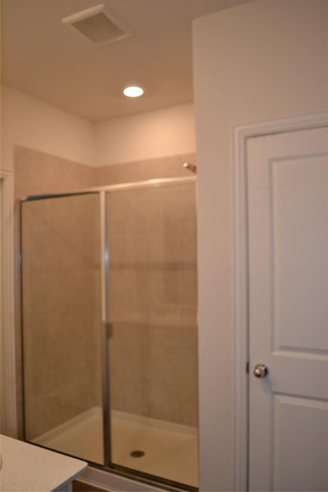 bathroom with vanity and an enclosed shower