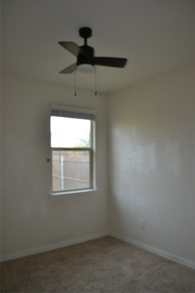 empty room with carpet flooring and ceiling fan